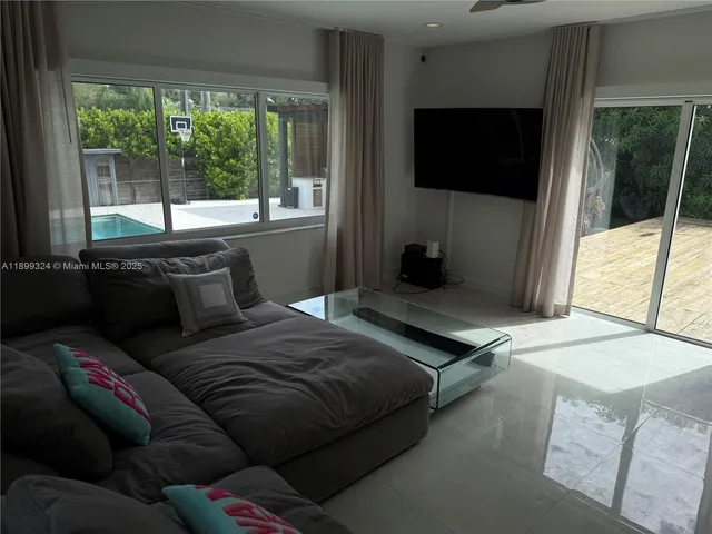 a bedroom with a bed and a flat tv screen on the dresser