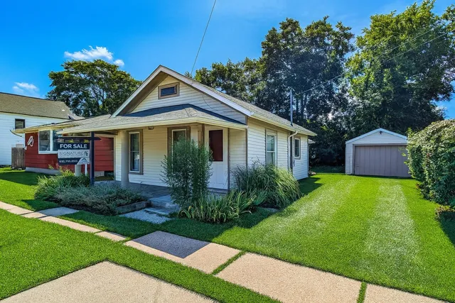 a front view of house with yard and green space