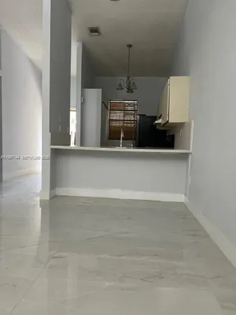 a view of a room with a wooden floor