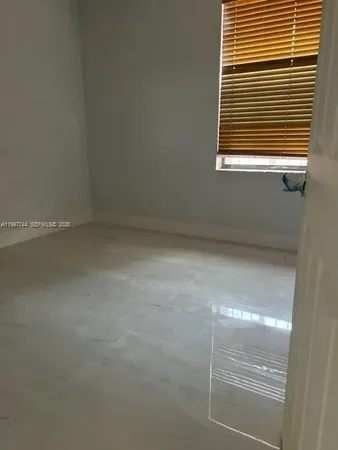 a bathroom with a granite countertop toilet and a sink