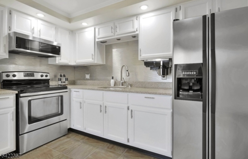 3 Prospect Street, Unit 2D Mount Arlington, NJ 07856 - Photo 5 of 20 a kitchen with stainless steel appliances granite countertop a refrigerator sink and stove