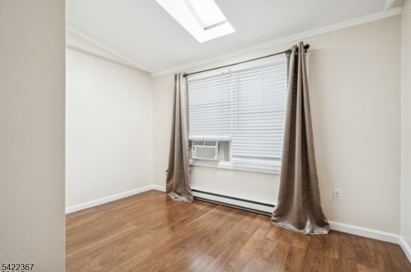 3 Prospect Street, Unit 2D Mount Arlington, NJ 07856 - Photo 8 of 20 a view of an empty room with wooden floor and closet