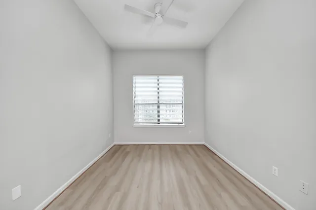 a view of wooden floor and windows in a room