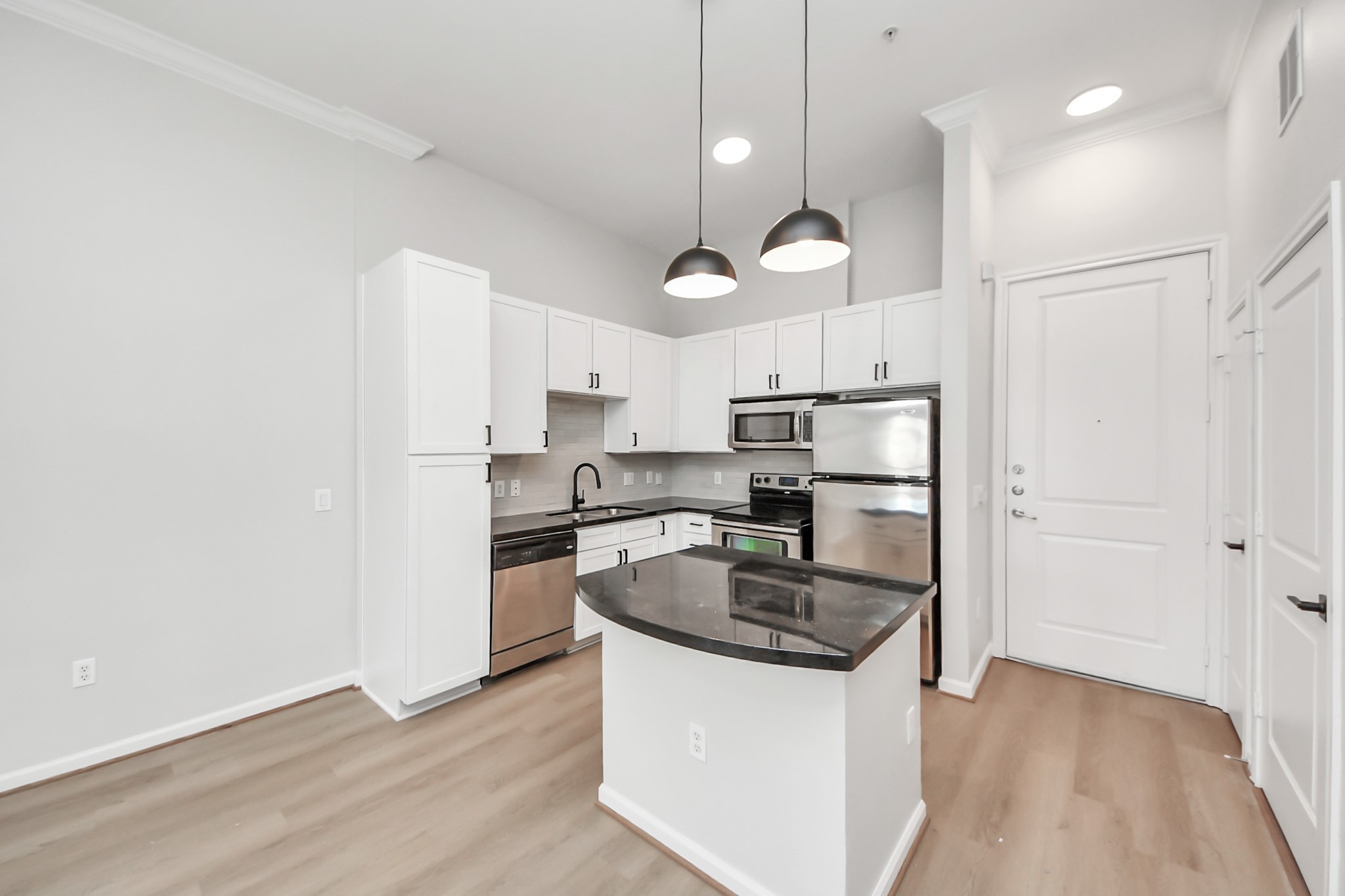 6363 San Felipe Street, Unit 243 Houston, TX 77057 - Photo 2 of 43 a kitchen with stainless steel appliances granite countertop a sink a stove a refrigerator and island with wooden floor