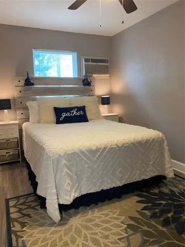 a large bed sitting in a bedroom next to a window