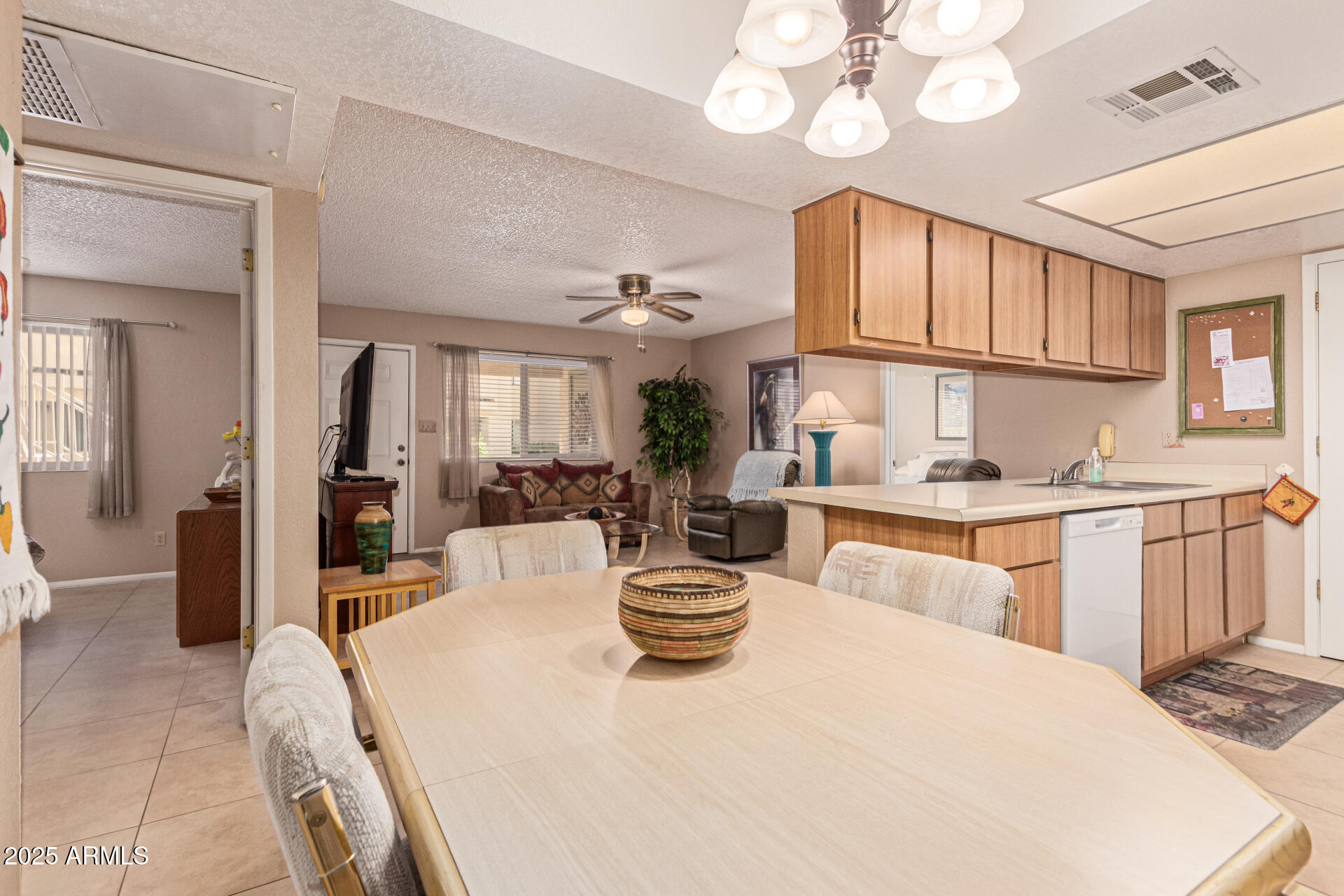 145 North 74th Street, Unit 127 Mesa, AZ 85207 - Photo 10 of 34 a view of a dining room with furniture a chandelier and kitchen view
