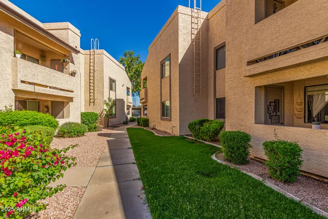 a view of a house with swimming pool and sitting area