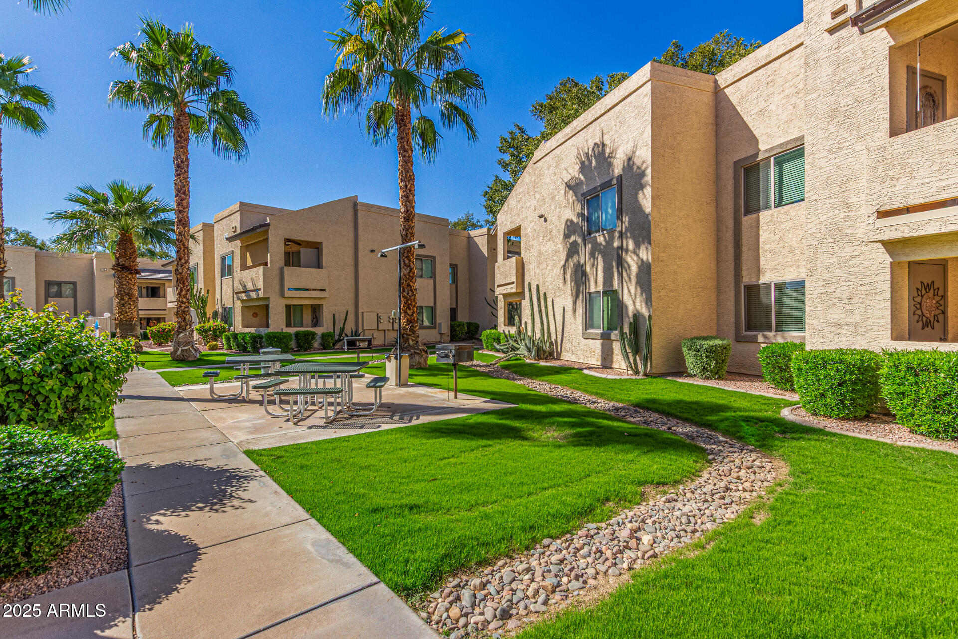 145 North 74th Street, Unit 127 Mesa, AZ 85207 - Photo 2 of 34 a front view of a house with garden and trees