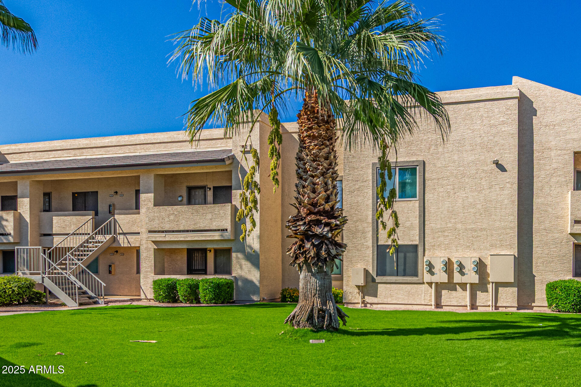 145 North 74th Street, Unit 127 Mesa, AZ 85207 - Photo 30 of 34 a front view of a house with a garden and trees