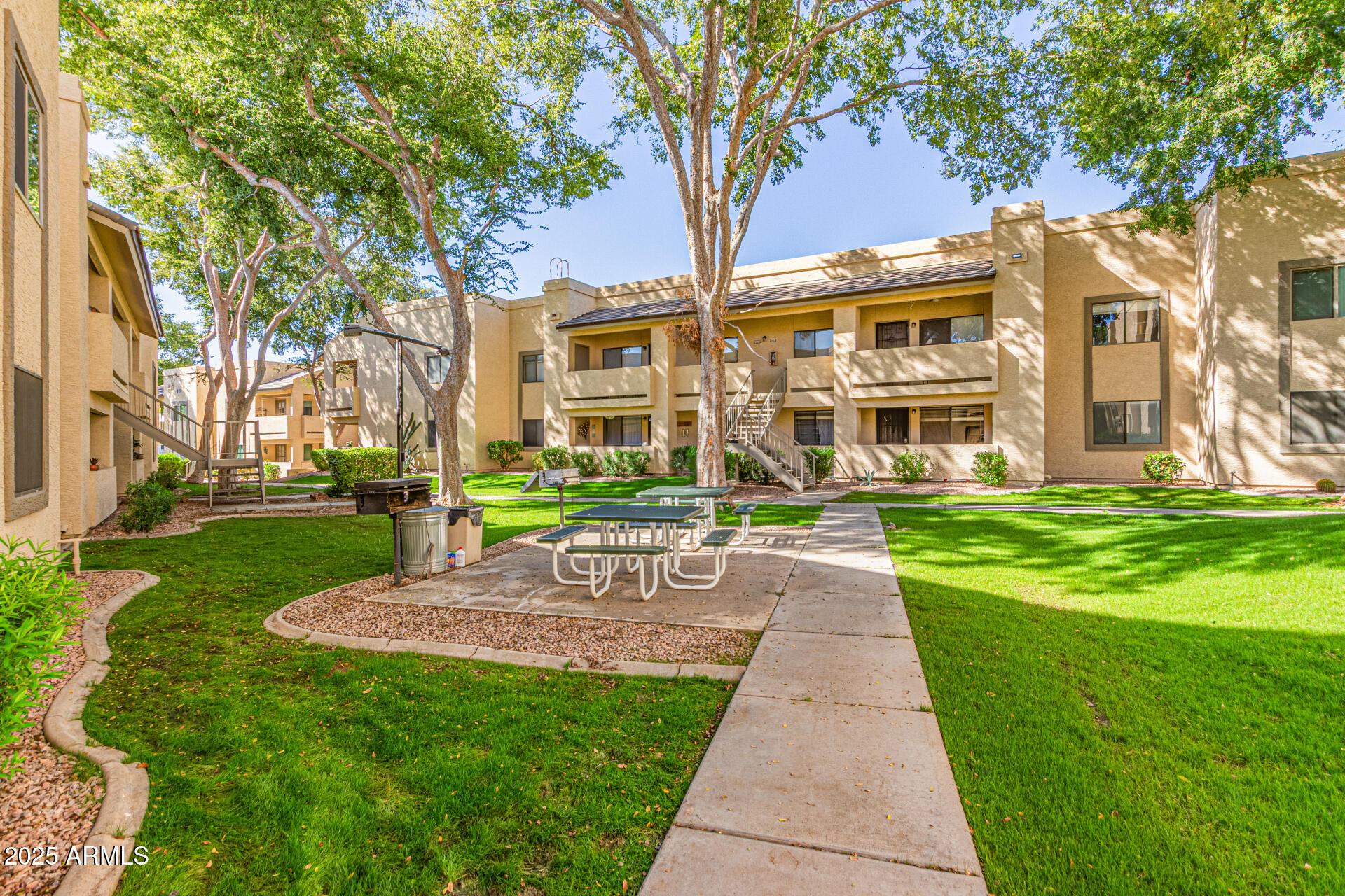 145 North 74th Street, Unit 127 Mesa, AZ 85207 - Photo 31 of 34 a front view of a building with a garden