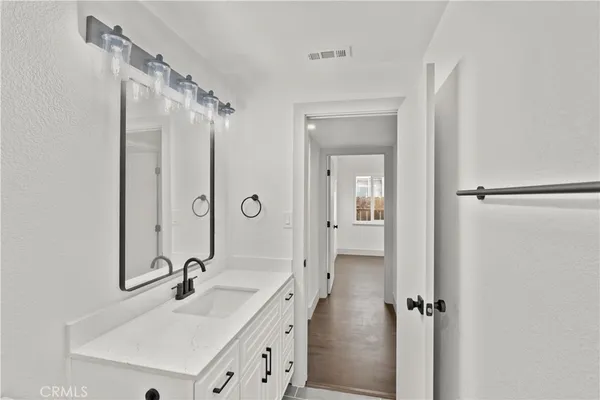 a bathroom with a double vanity sink a mirror and shower