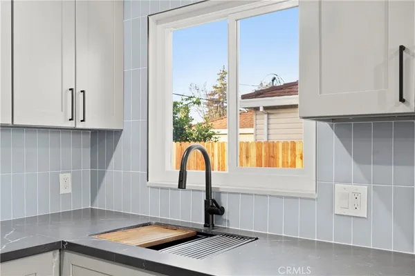 a kitchen with a sink and a window