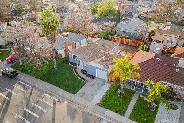 an aerial view of a house with garden space and street view