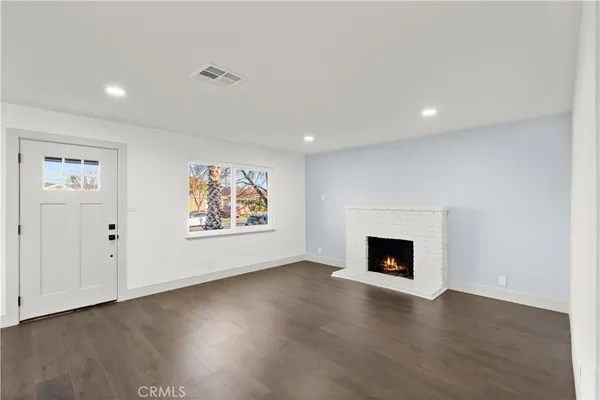 an empty room with window and wooden floor