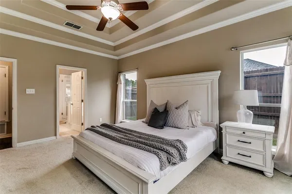 a bedroom with a bed and ceiling fan