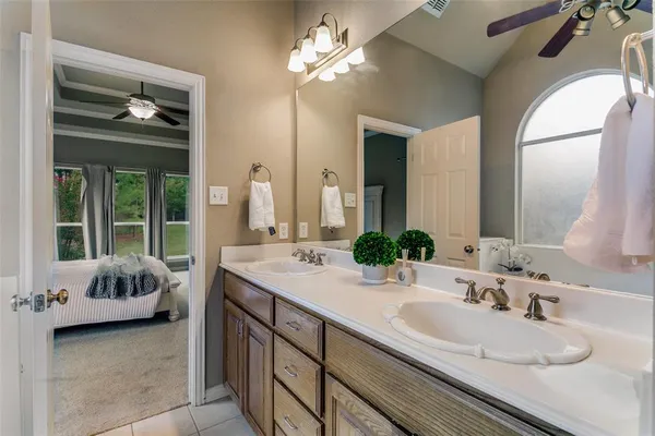 a en suite bathroom with a granite countertop tub and a double vanity sink