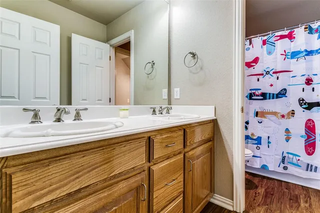 a bathroom with a sink double vanity and a mirror