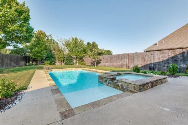 a view of a backyard with swimming pool
