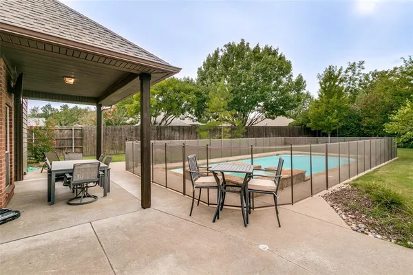 a view of a chairs and table in the patio