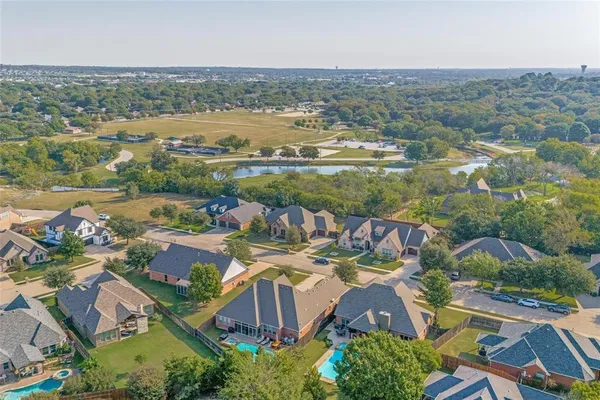 an aerial view of residential houses with outdoor space and river