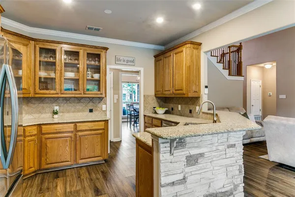 a kitchen with a stove sink and cabinets