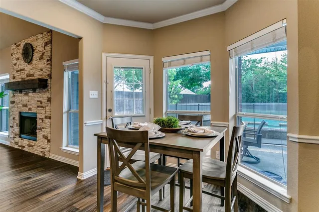 a dining room with furniture and wooden floor