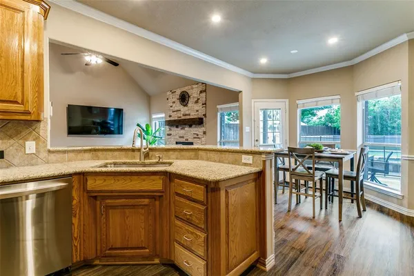 a kitchen with a stove a sink a dining table and chairs