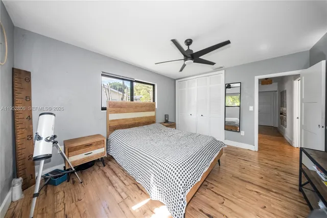 a bedroom with a bed and wooden floor