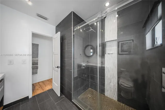 a bathroom with a glass shower door