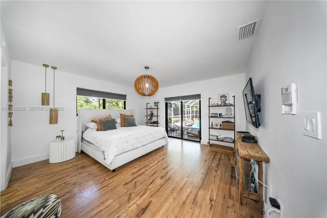 a bedroom with a bed and a large window