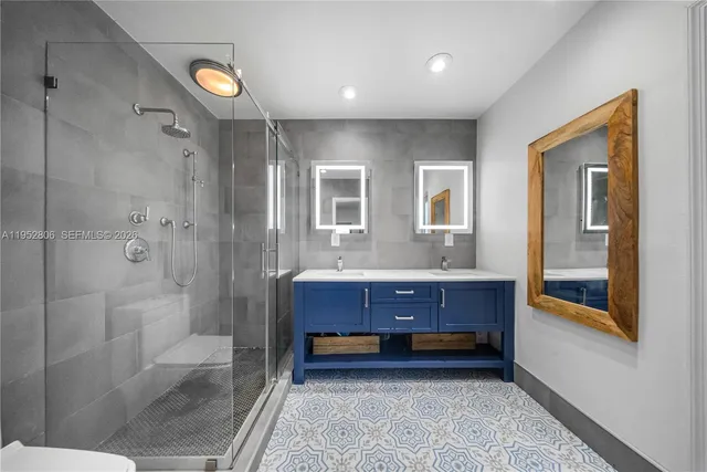 a bathroom with a tub shower and sink