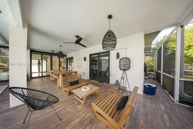 a very nice looking living room with a large window and wooden floor