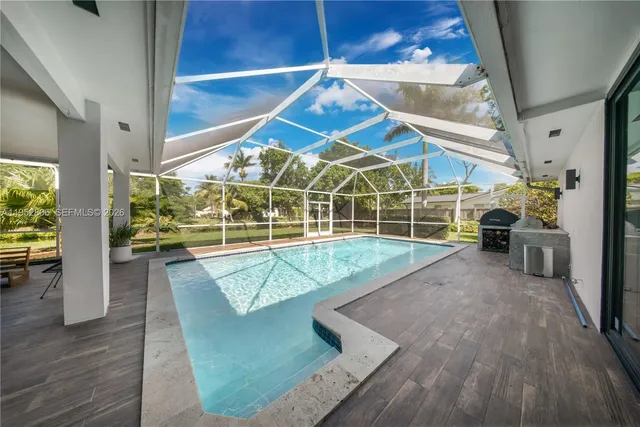 a view of a swimming pool with seating space