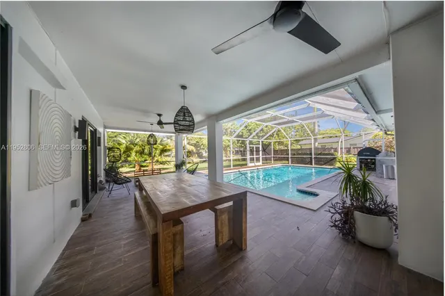 a dining room with furniture and a floor to ceiling window