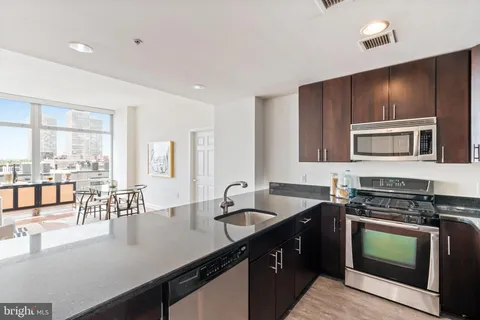 a kitchen with a stove a sink and a microwave