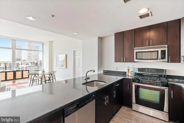 a kitchen with a stove a sink and a microwave