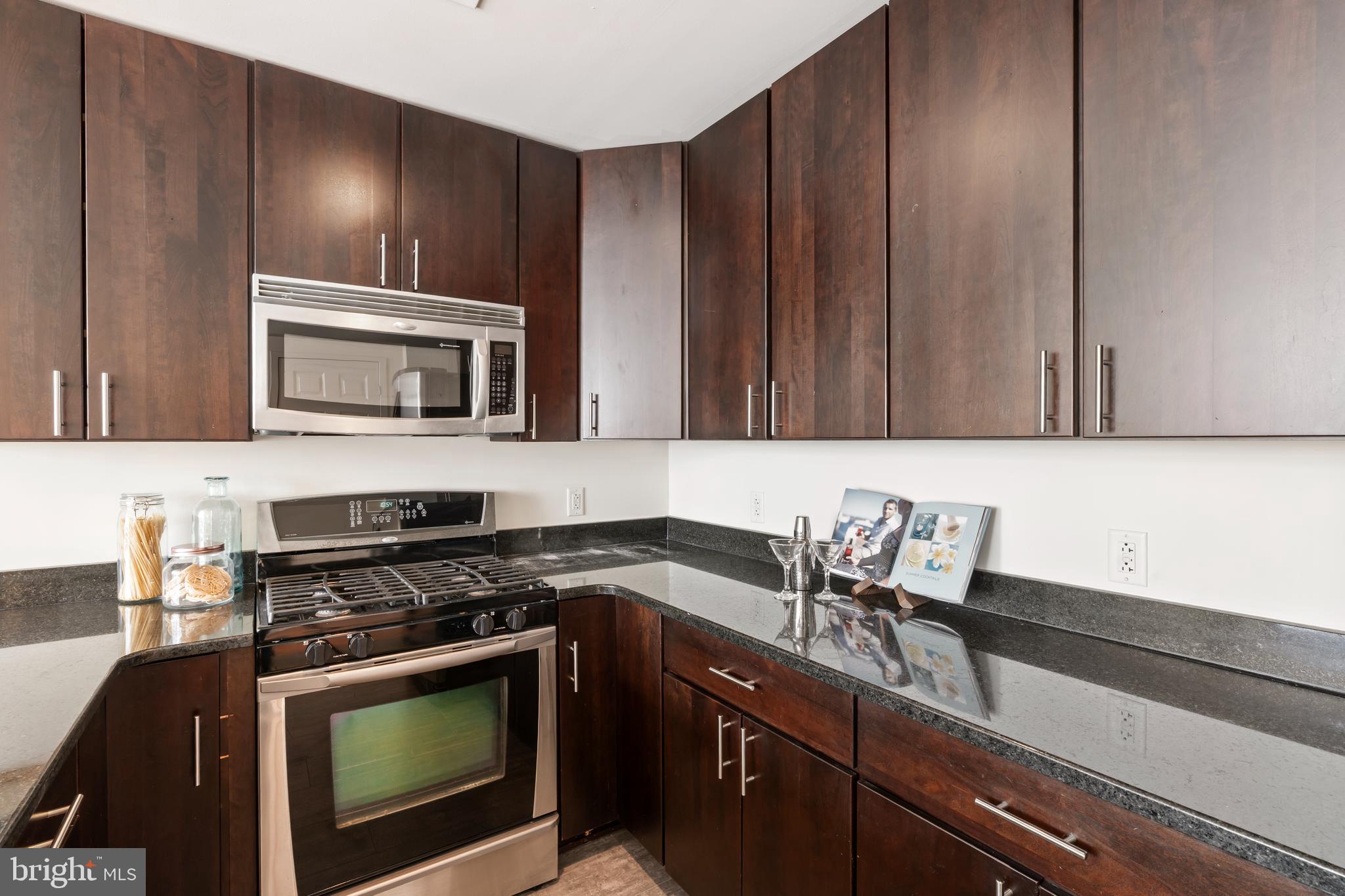 22 South Front Street, Unit 603 Philadelphia, PA 19106 - Photo 12 of 44 a kitchen with a stove a sink and a microwave