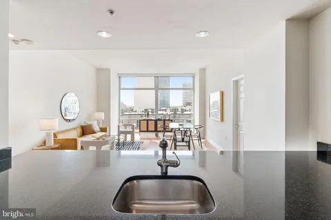 a kitchen with a sink and a large window