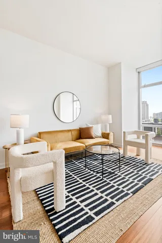 a living room with furniture a rug and a table