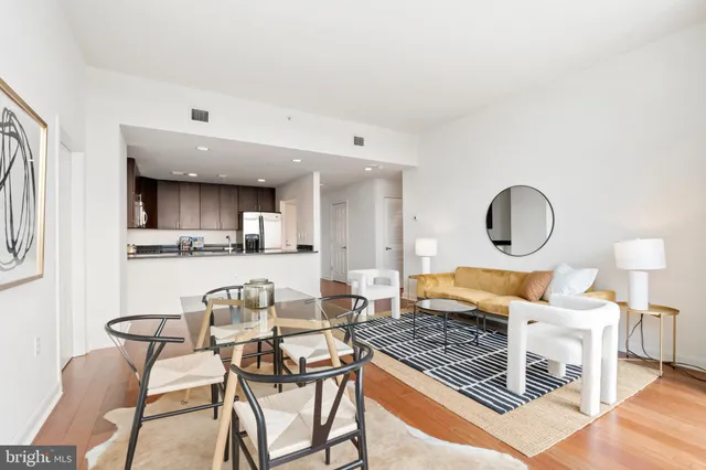 a dining room with furniture and a floor to ceiling window