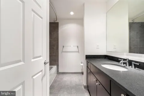 a bedroom with a large bed and a lamp next to a window