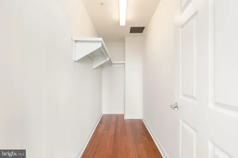 a bathroom with a granite countertop sink a mirror and a shower
