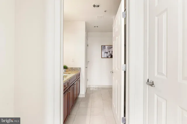 a bathroom with a granite countertop sink and shower