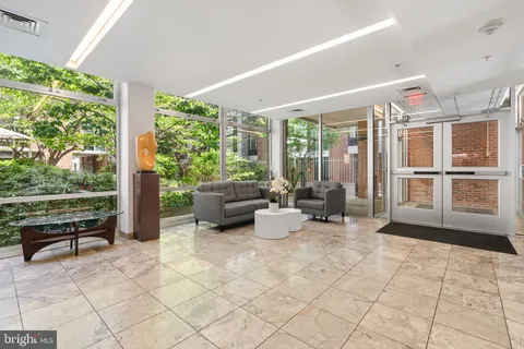 a living room with patio furniture and a large window