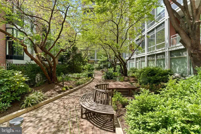 a view of a hallway with wooden floor and furniture