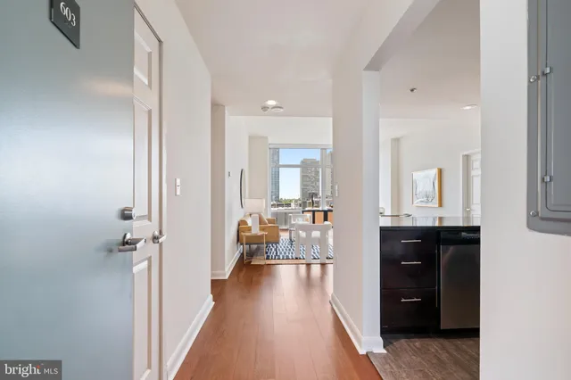 a kitchen with a refrigerator and a stove top oven