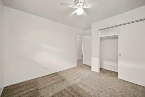 an empty room with a empty space and a ceiling fan