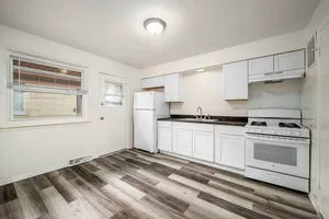 a kitchen with stainless steel appliances granite countertop a stove and a refrigerator