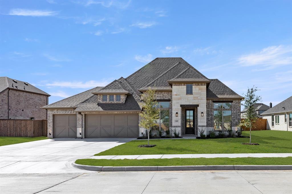 610 Tenor Drive Forney, TX 75126 - Photo 28 of 30 a front view of a house with a garden and trees