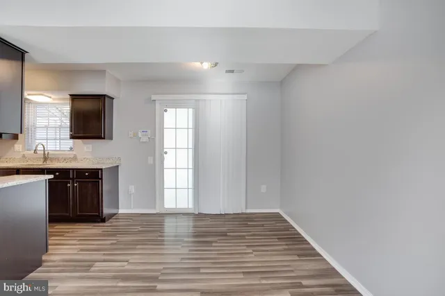 a view of a kitchen from a hallway
